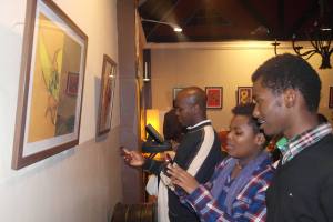 Guests admiring artwork during the opening of the exhibition